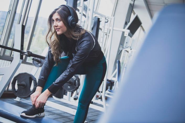 Woman with headphones on in gym