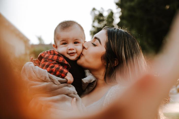 Mother kissing son