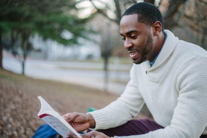 Man reading outside