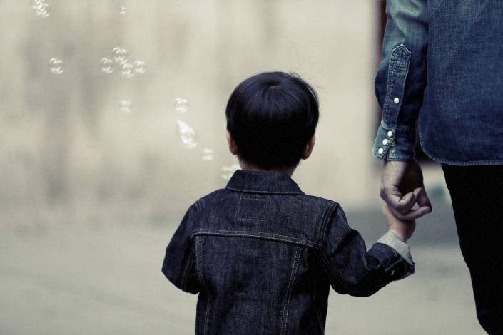Child holding parent's hand