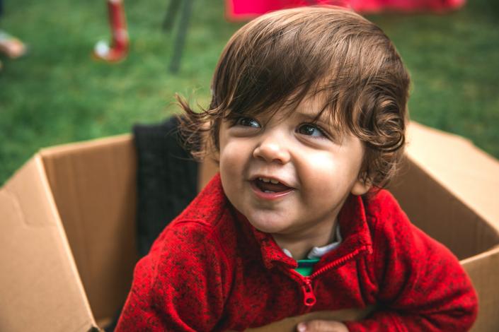 Boy with long hair smiling