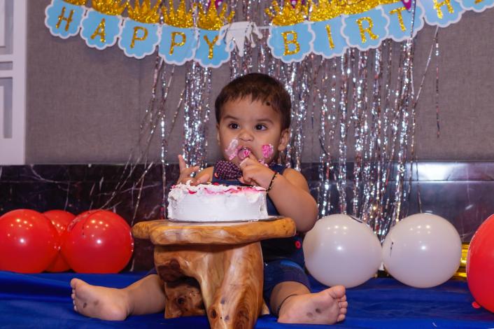 Baby eating birthday cake