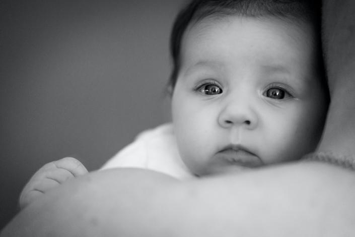 Baby holding on to mother