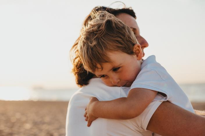 Adult hugging child