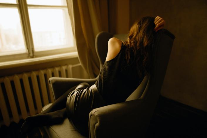 Person sitting in chair looking away