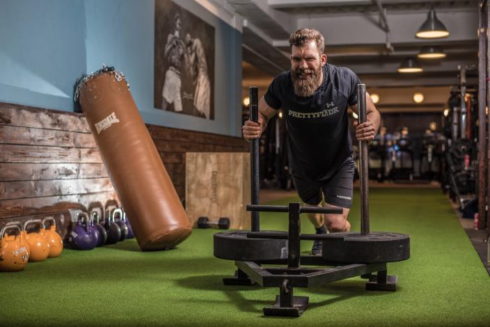 Man pushing a weight sled