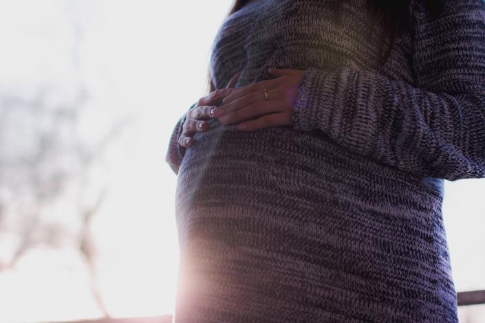 Pregnant woman holding belly