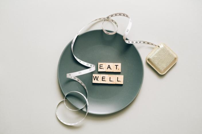 "Eat Well" letters on a plate