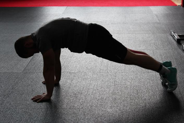 Man doing plank on floor