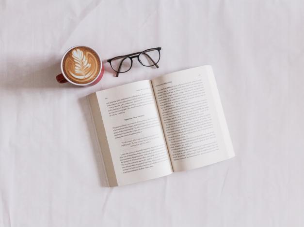 Open book next to coffee