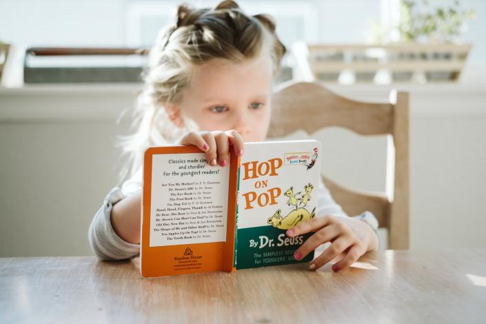 Girl reading Hop on Pop