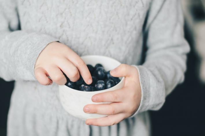 Child eating blueberries