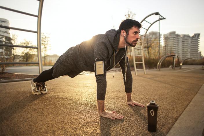 Man doing plank outside