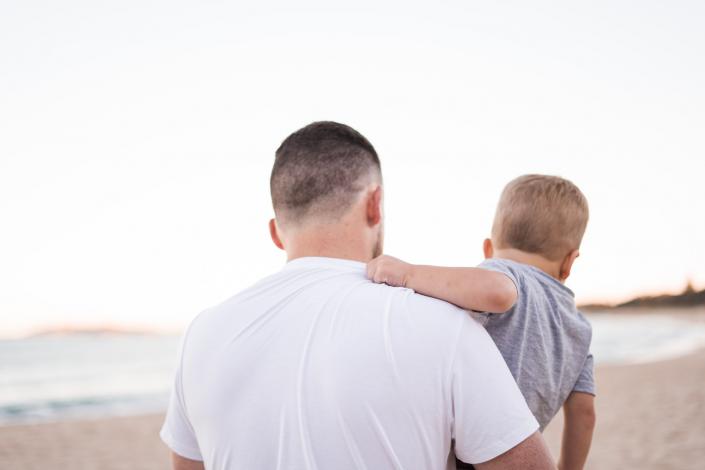 Man at beach with child