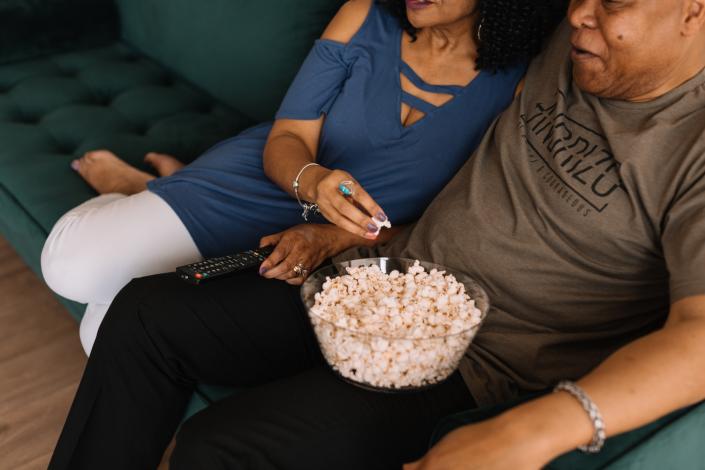 Man and woman eating popcorn from bowl