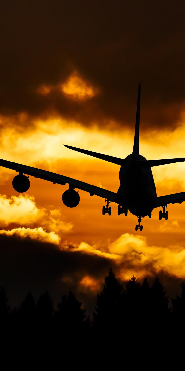 Airplane in air during sunset