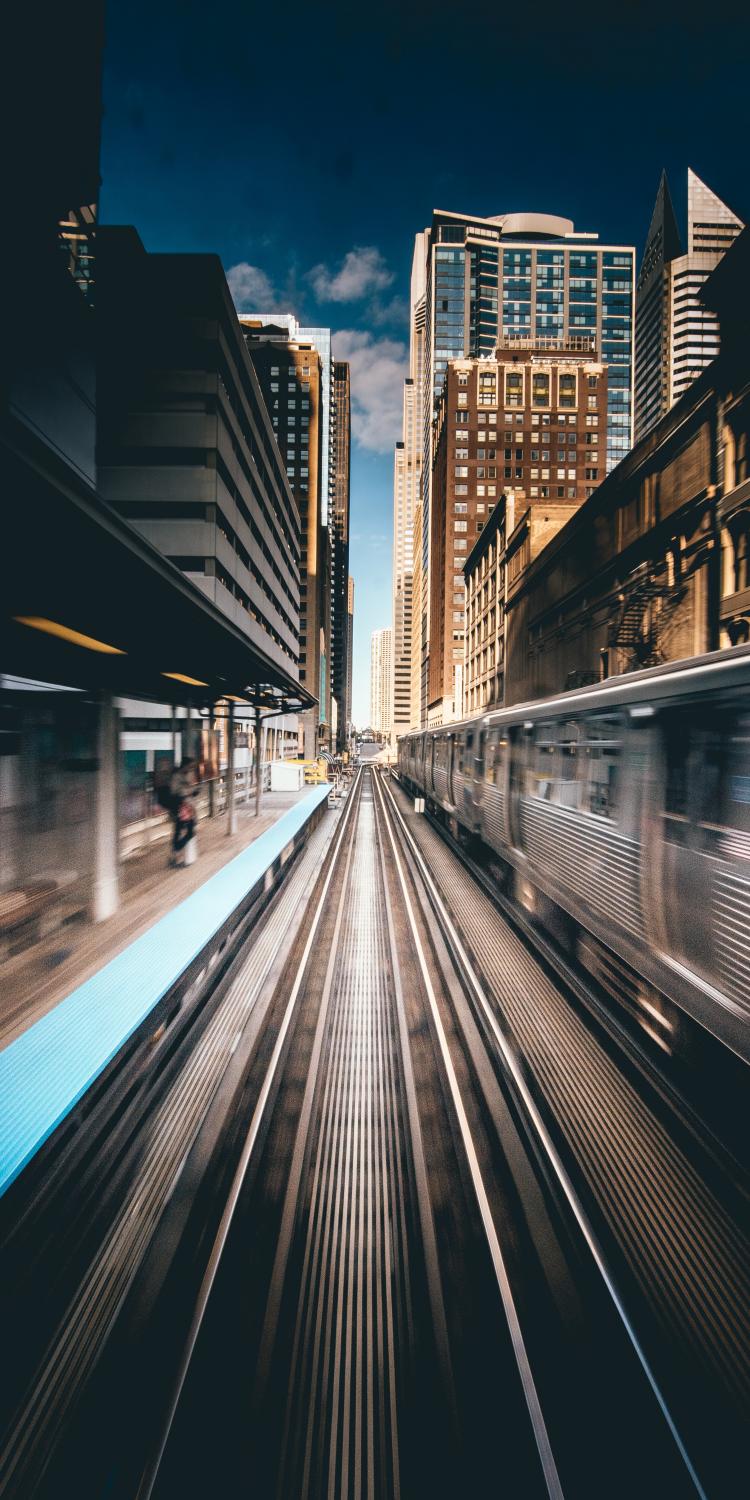 Train driving with building in background