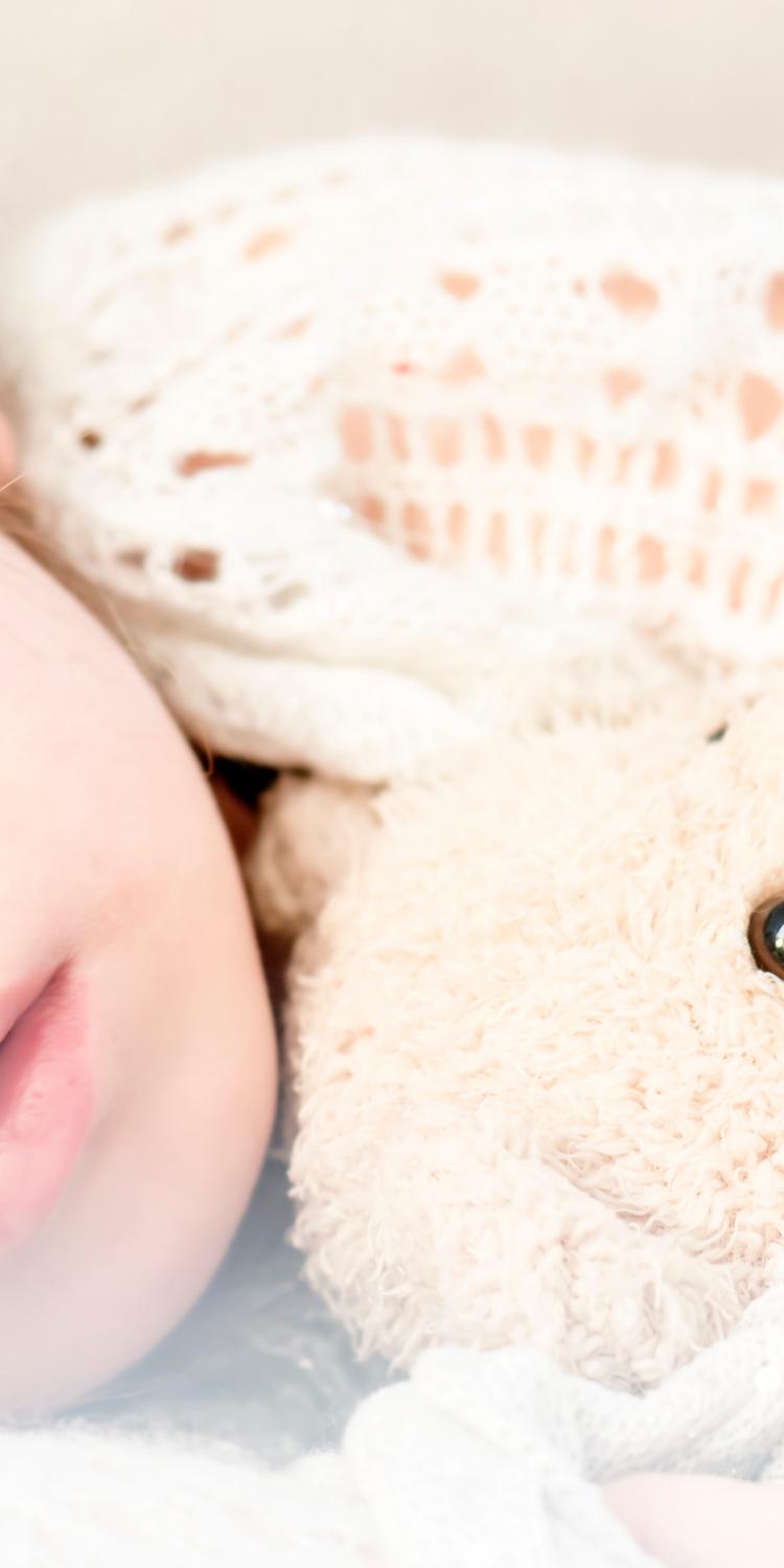 Girl sleeping with teddy bear