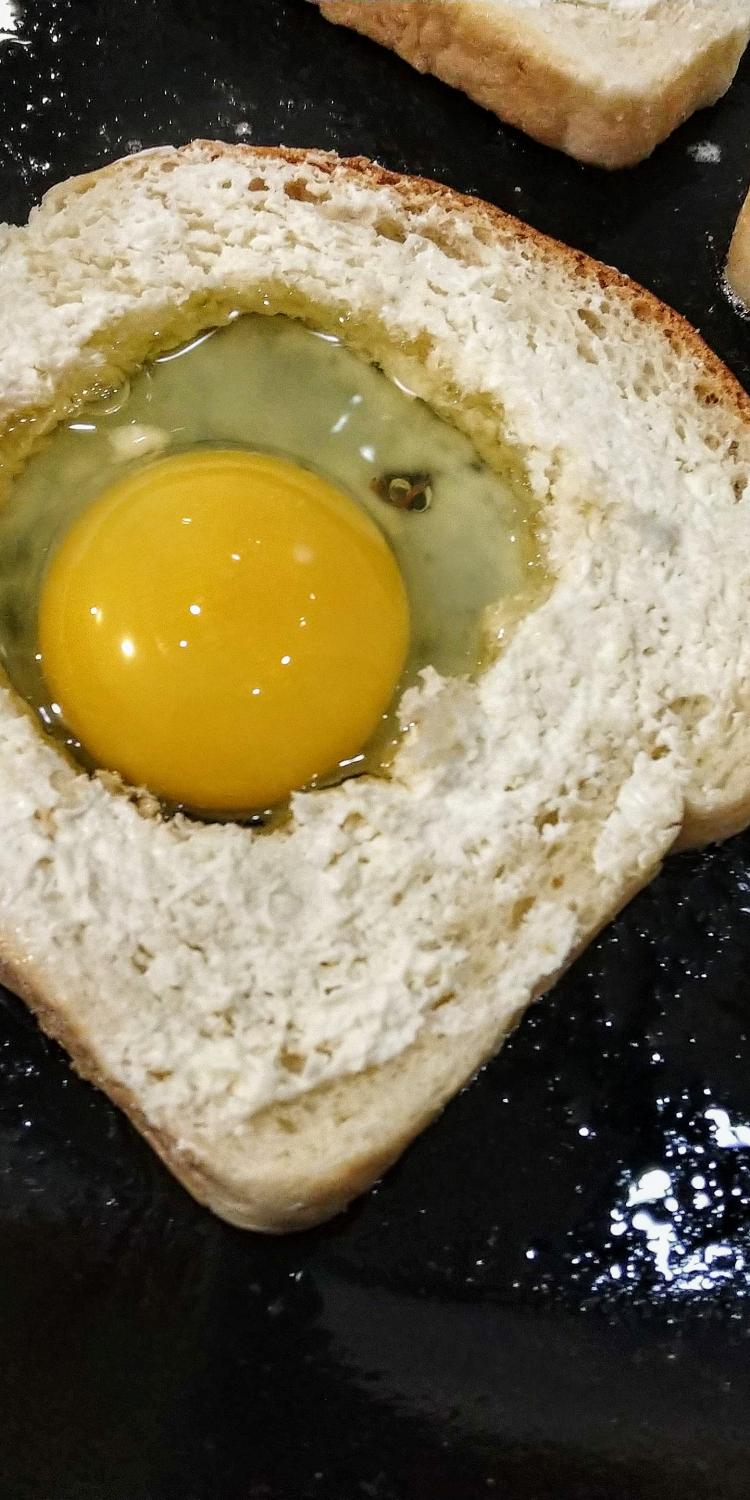 Bread with egg in the middle in frying pan