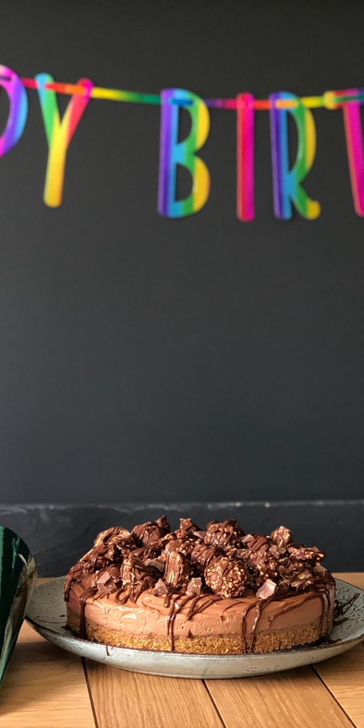 Cake in front of Happy Birthday banner