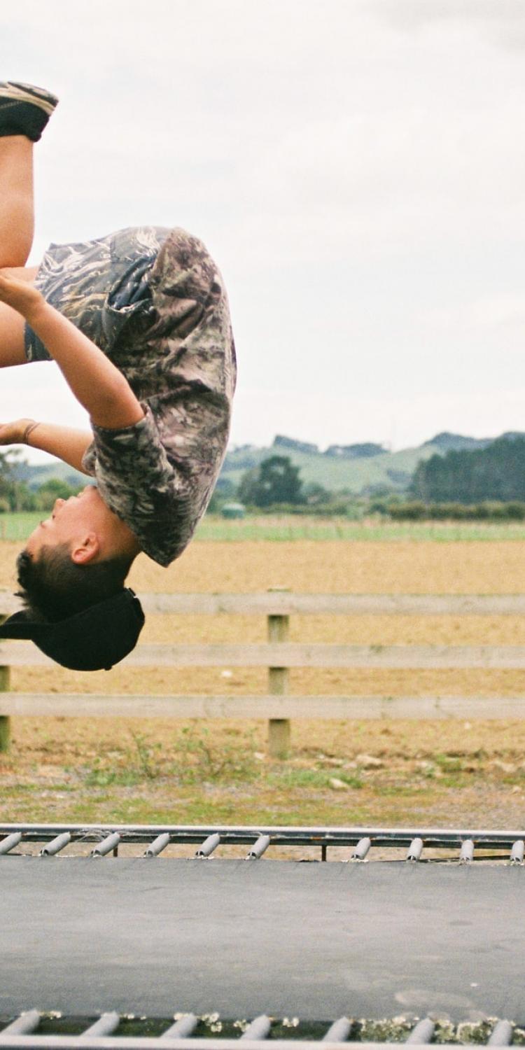 Child doing flip on a trampoline