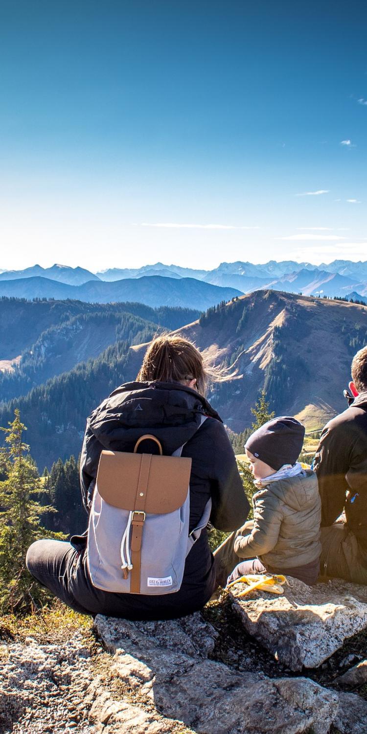 Kids and parents sitting on mountain