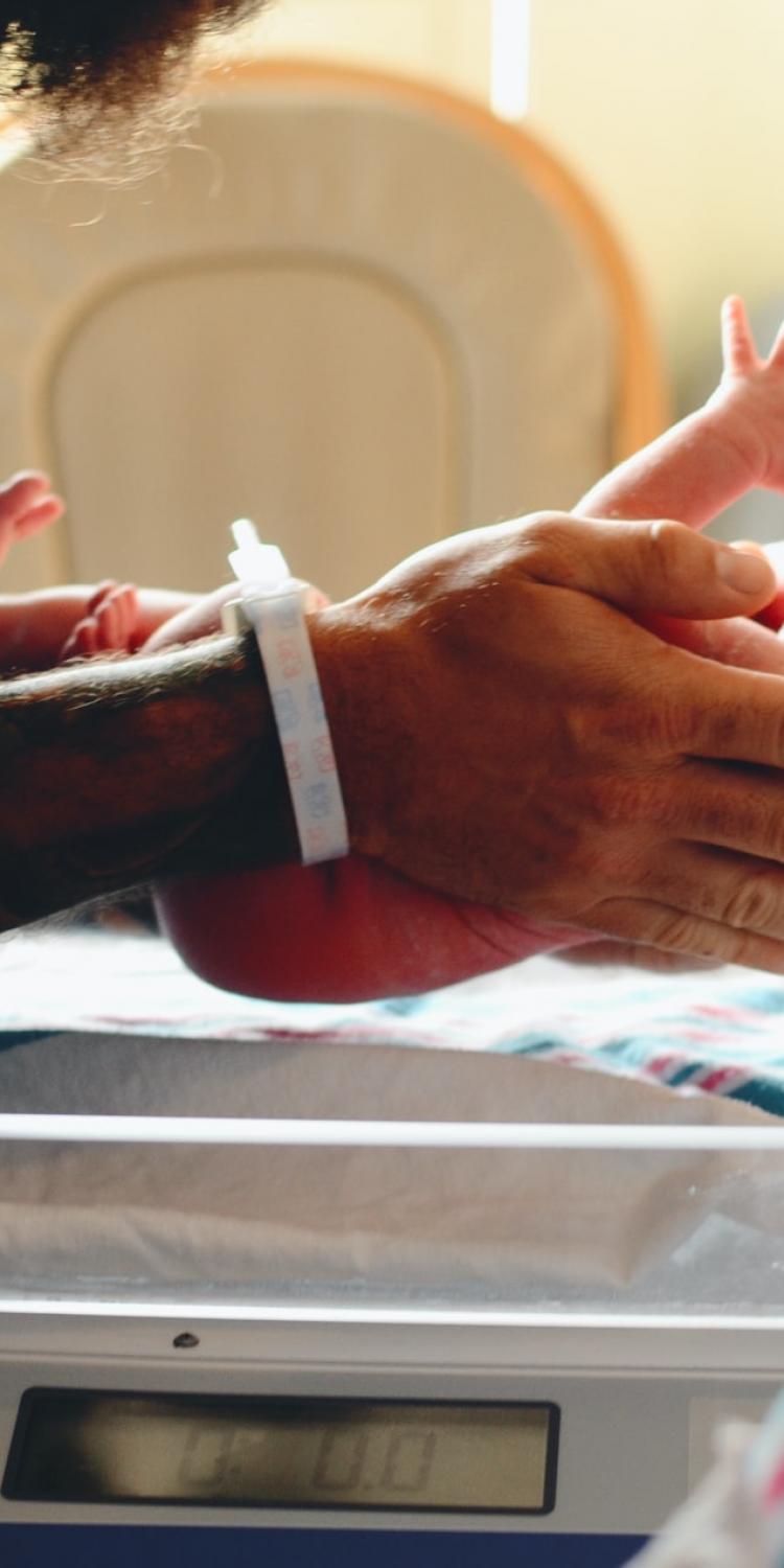 Newborn baby being held by doctor