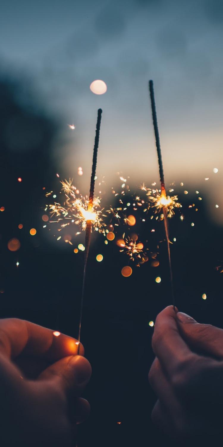 Two sparklers being held