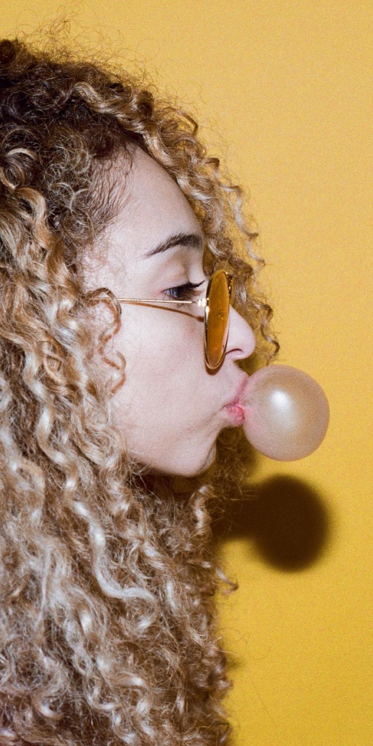 Woman blowing bubble with gum