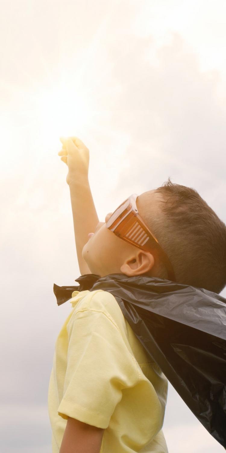 Child in cape and glasses