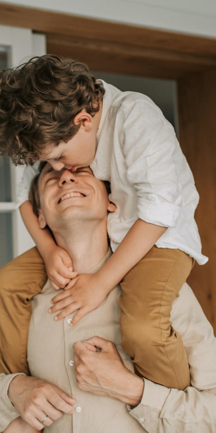 Man holding son on shoulders