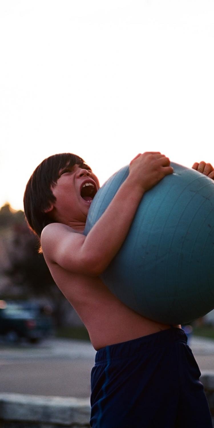 Boy holding yoga ball