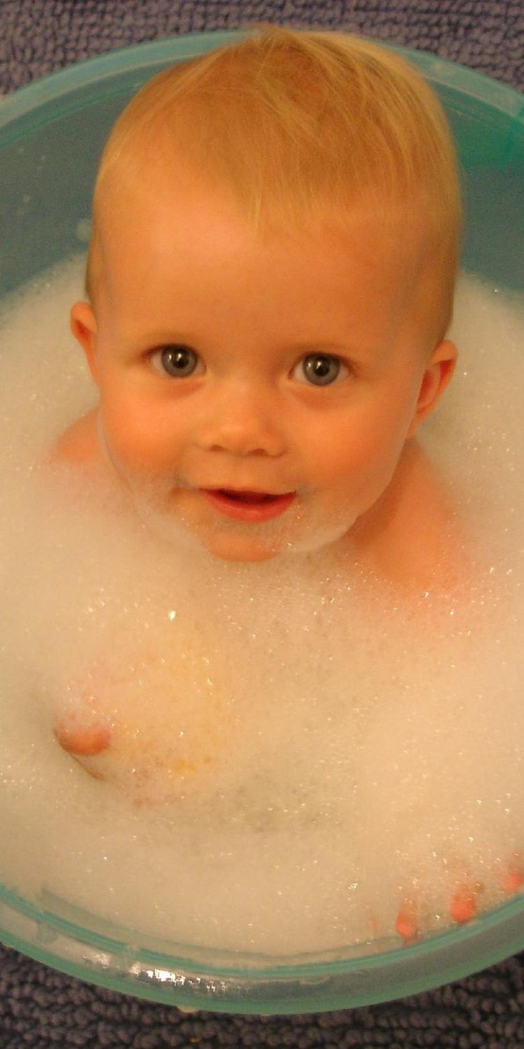 Baby in bucket of bubbles
