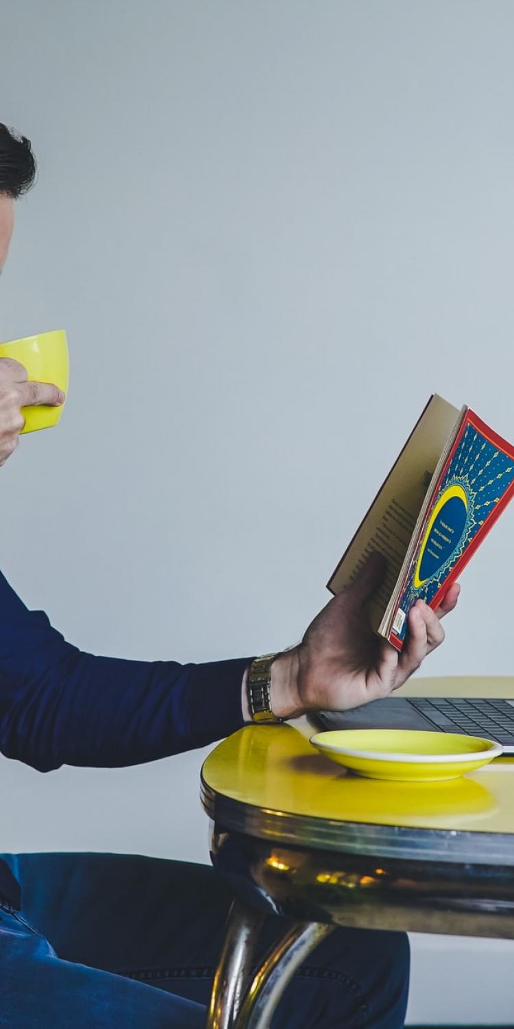 Person reading and drinking