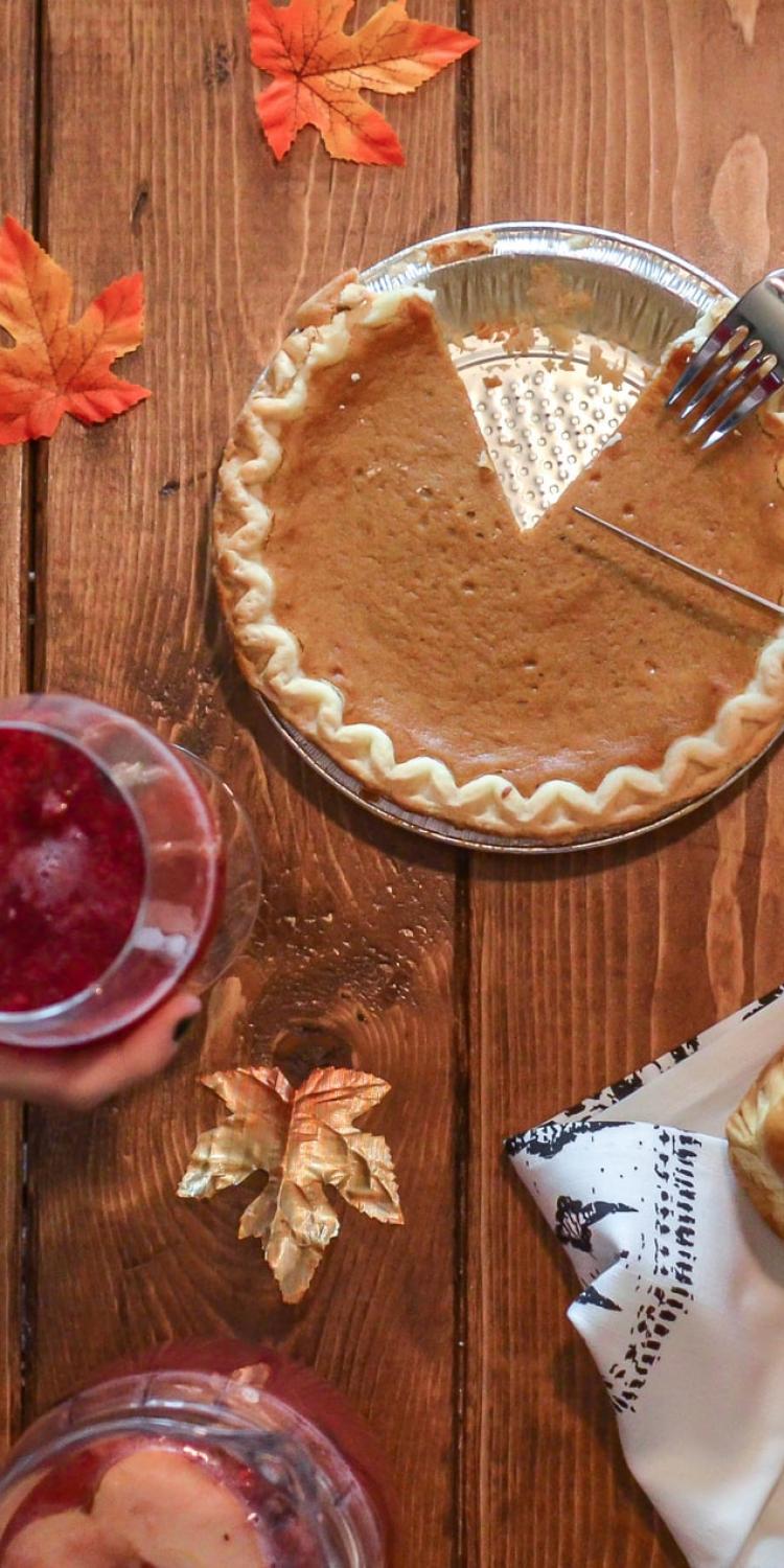 Person slicing pumpkin pie