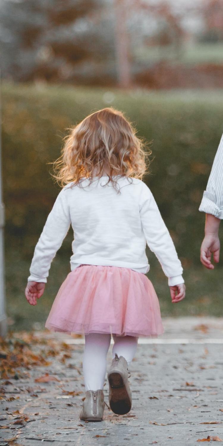 Boy and girl walking across a bridge