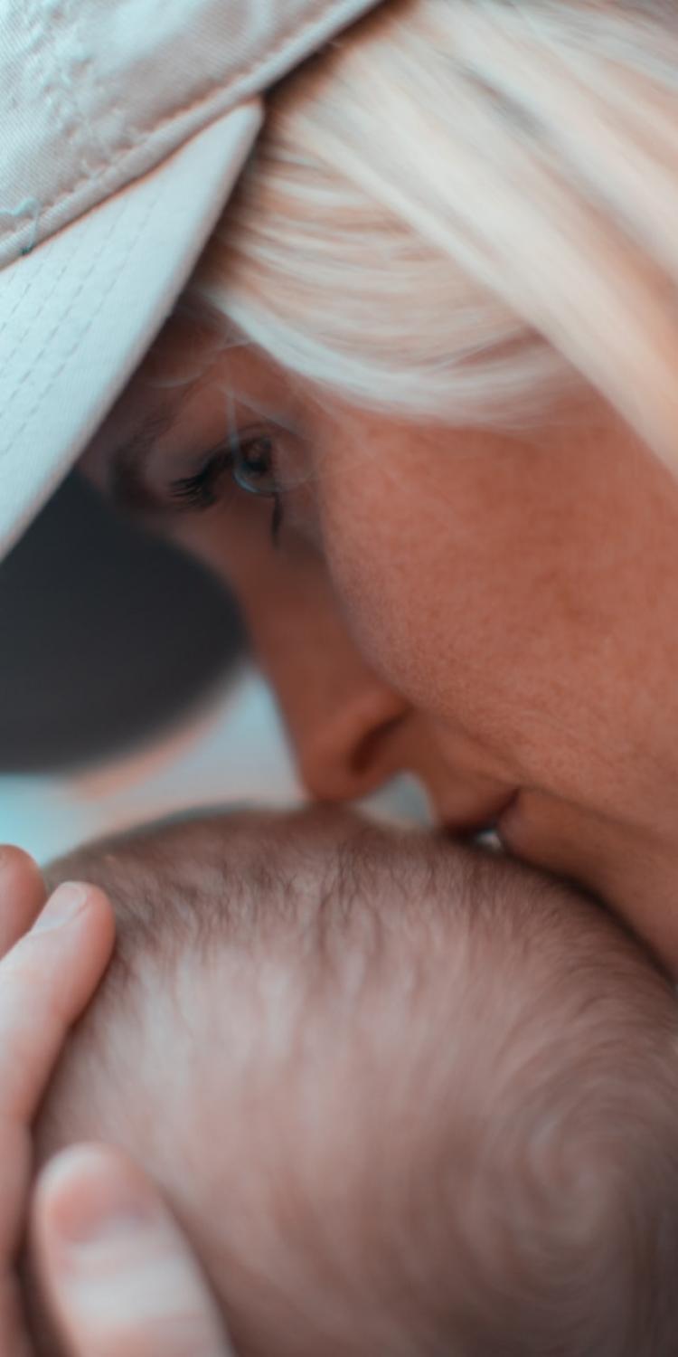 Woman kissing baby