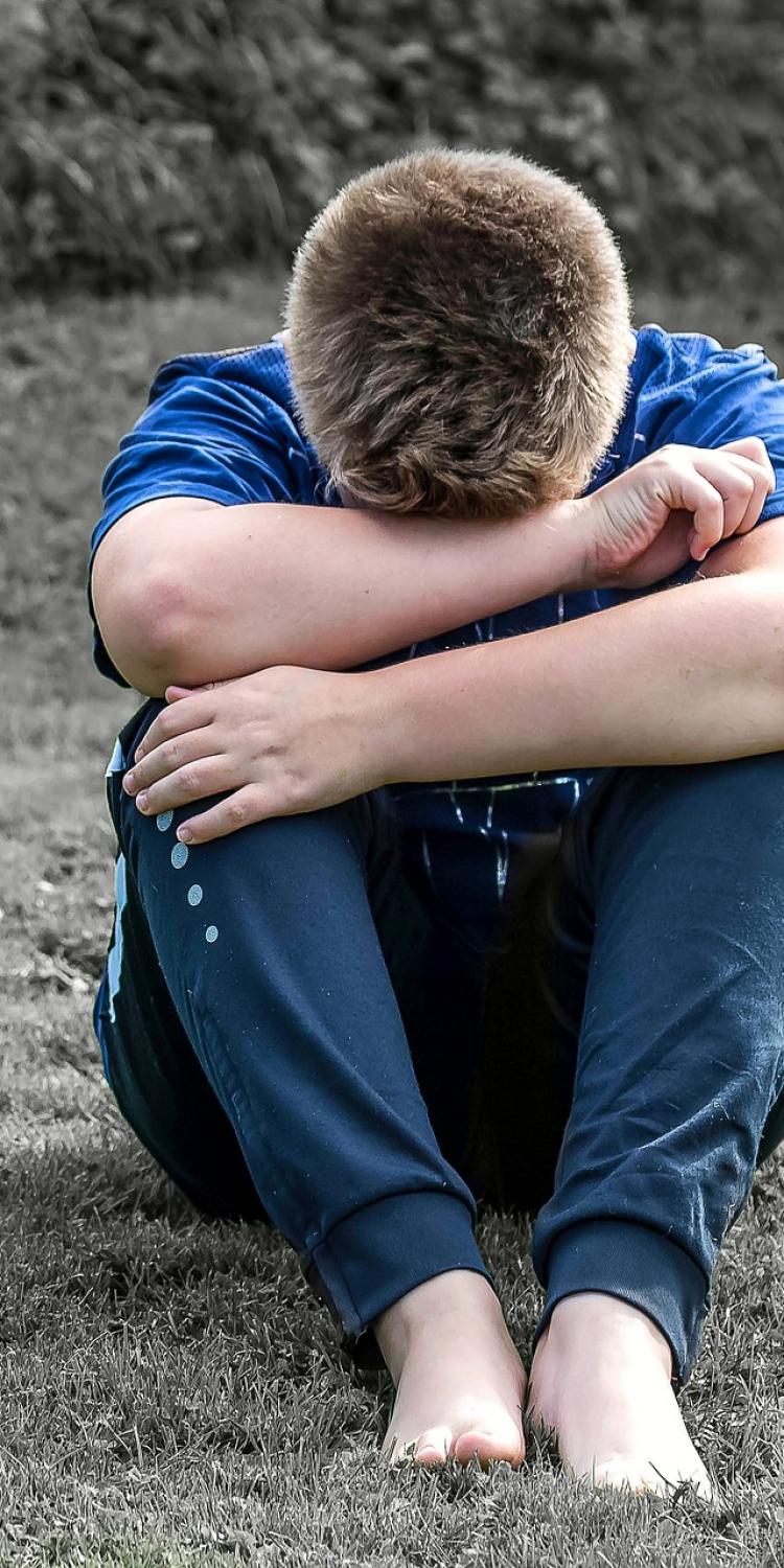 Boy sitting on ground