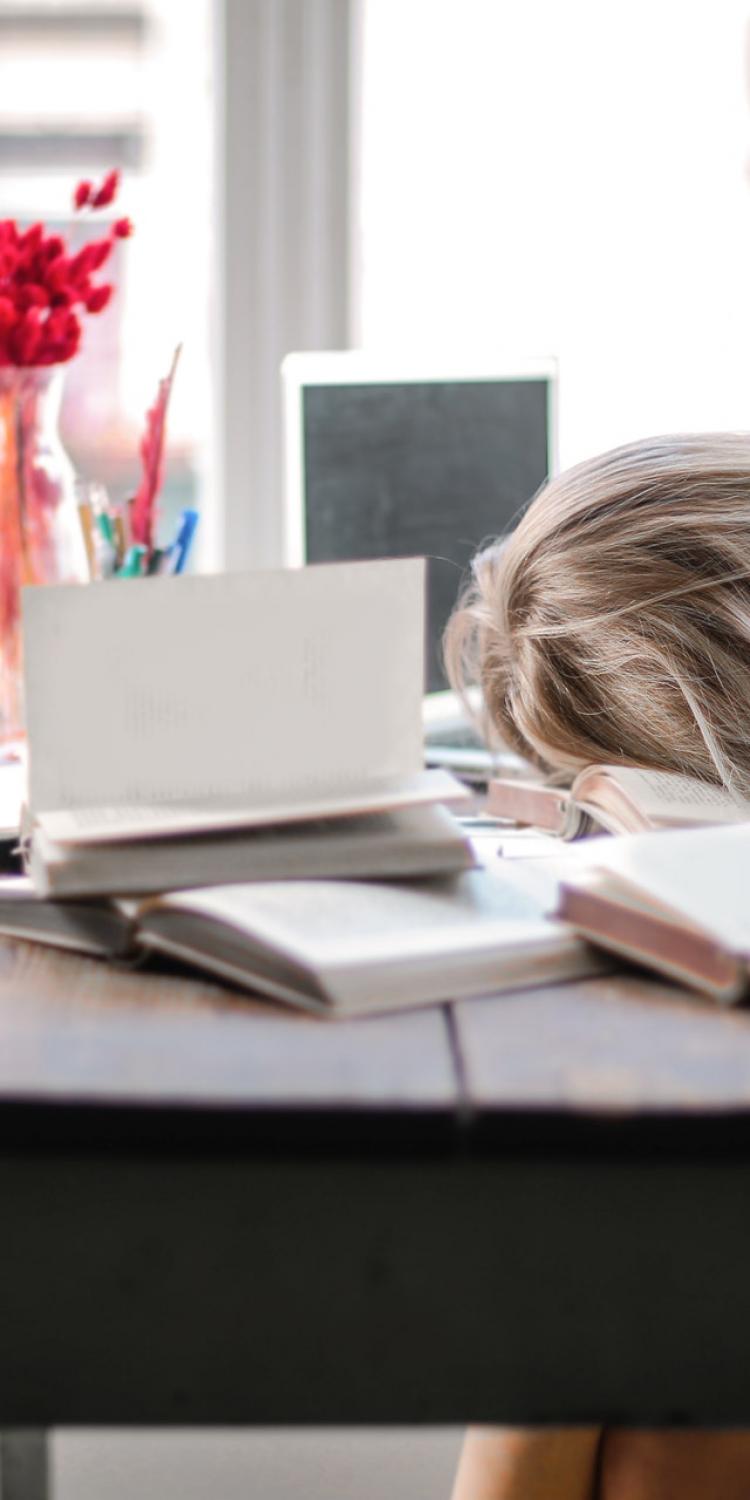 Girl with head on desk