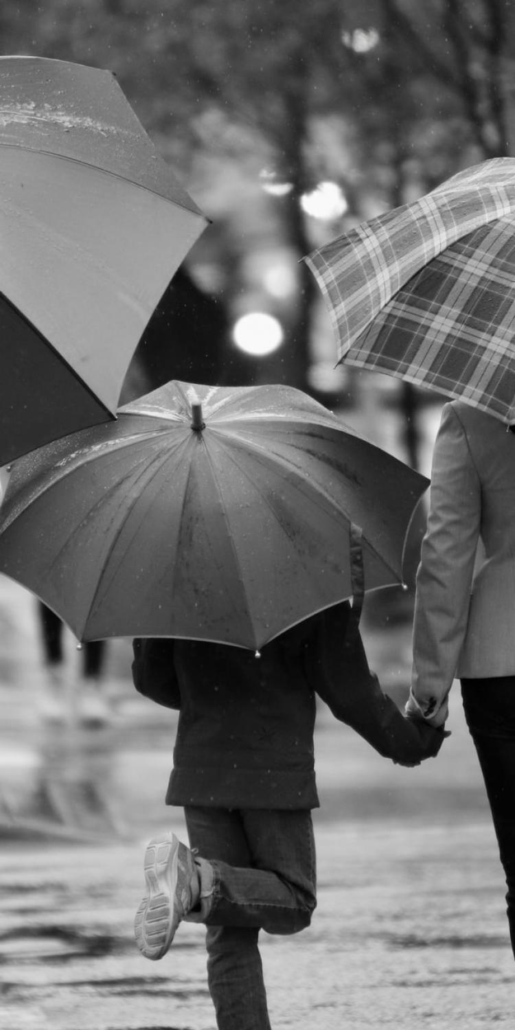 Family holding umbrellas