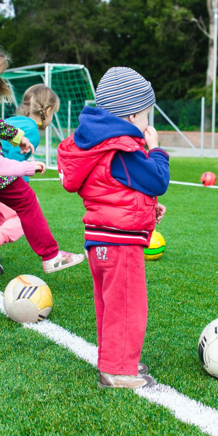Kids kicking soccer balls