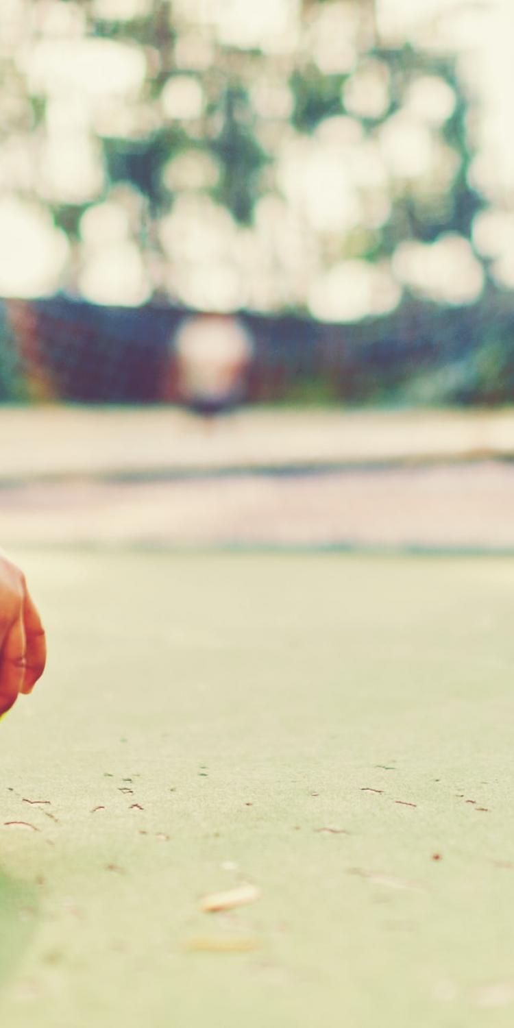 Child holding a tennis ball