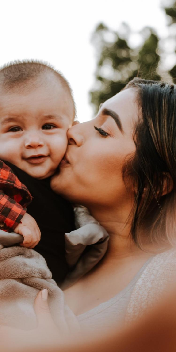 Mother kissing son