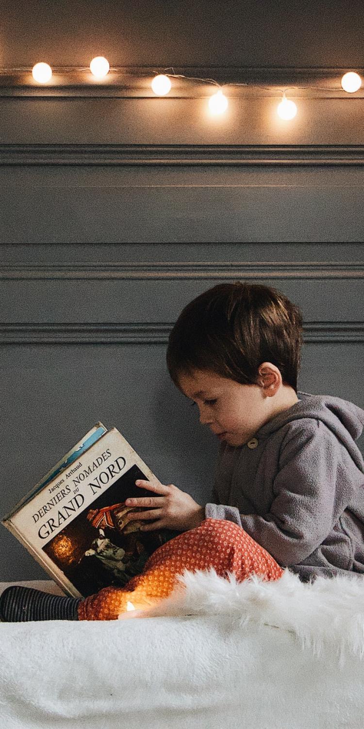 Child reading in bed