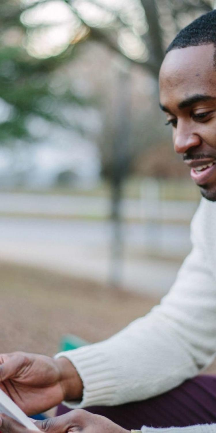 Man reading outside