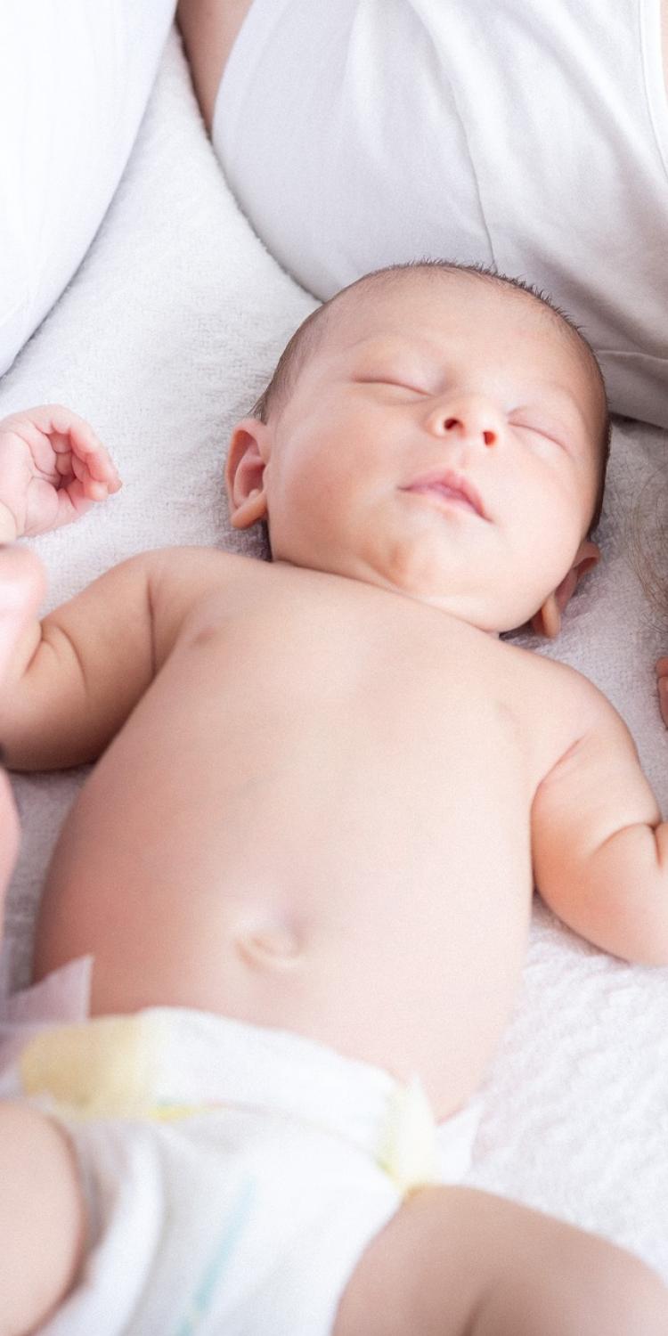 Parents laying down with baby