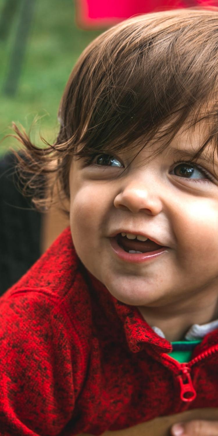 Boy with long hair smiling