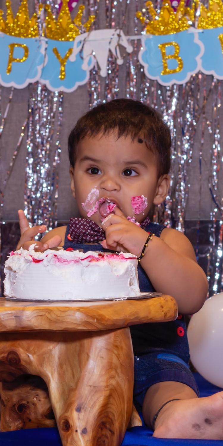 Baby eating birthday cake