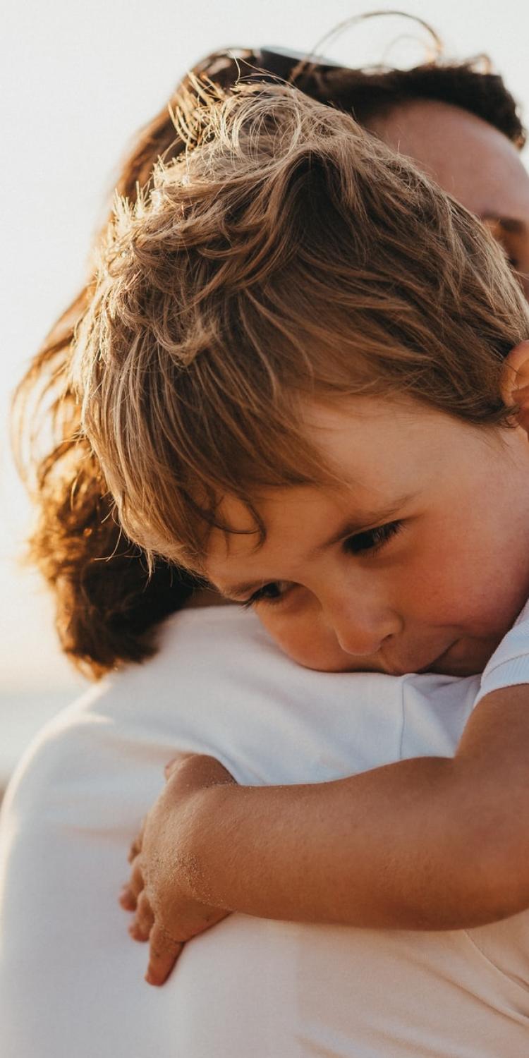 Adult hugging child