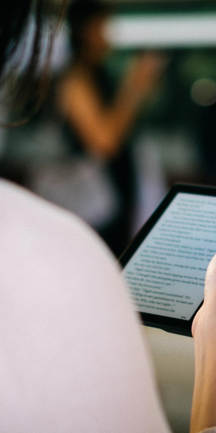 Woman holding Kindle and reading